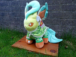 a leafeon wearing a onesie and a cape